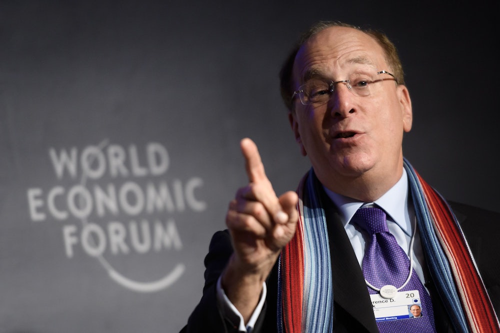 BlackRock CEO Larry Fink gesticulates while talking.