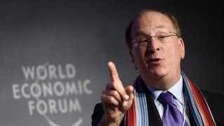 BlackRock CEO Larry Fink gesticulates while talking.