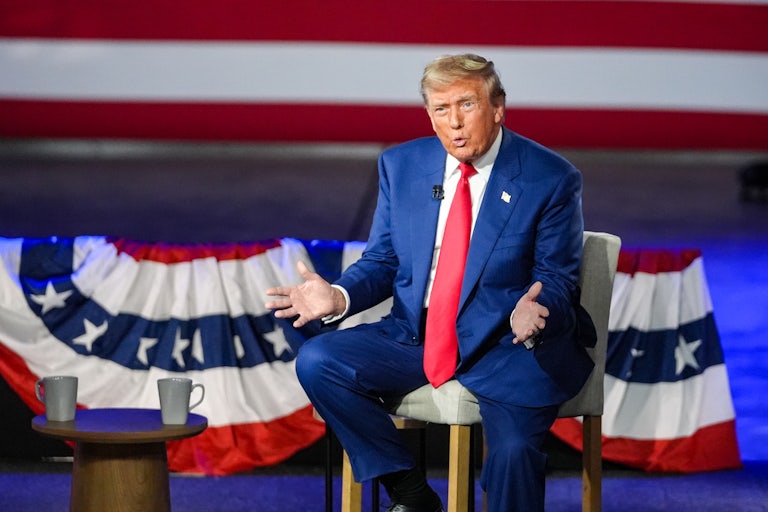 Donald Trump gestures while onstage during his town hall with Sean Hannity