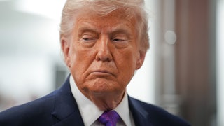 Donald Trump grimaces while looking sideways to his right