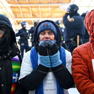 Faith leaders pray during a protest at the Minneapolis airport.