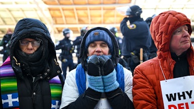 Faith leaders pray during a protest at the Minneapolis airport