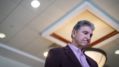 Senator Joe Manchin glances at the ground during a press conference.