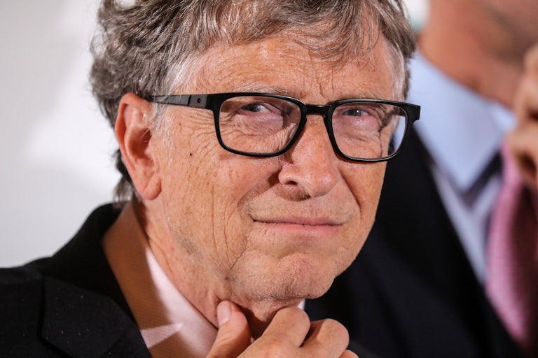 Bill Gates strokes his neck