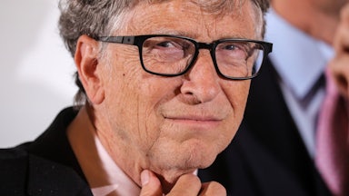 Bill Gates strokes his neck