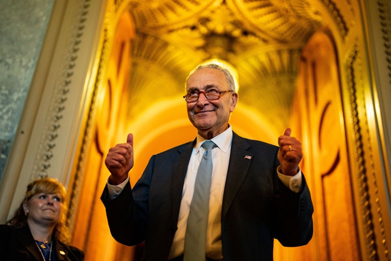 Senate Majority Leader Chuck Schumer flashed two thumbs up in celebration of the passage of the Inflation Reduction Act.