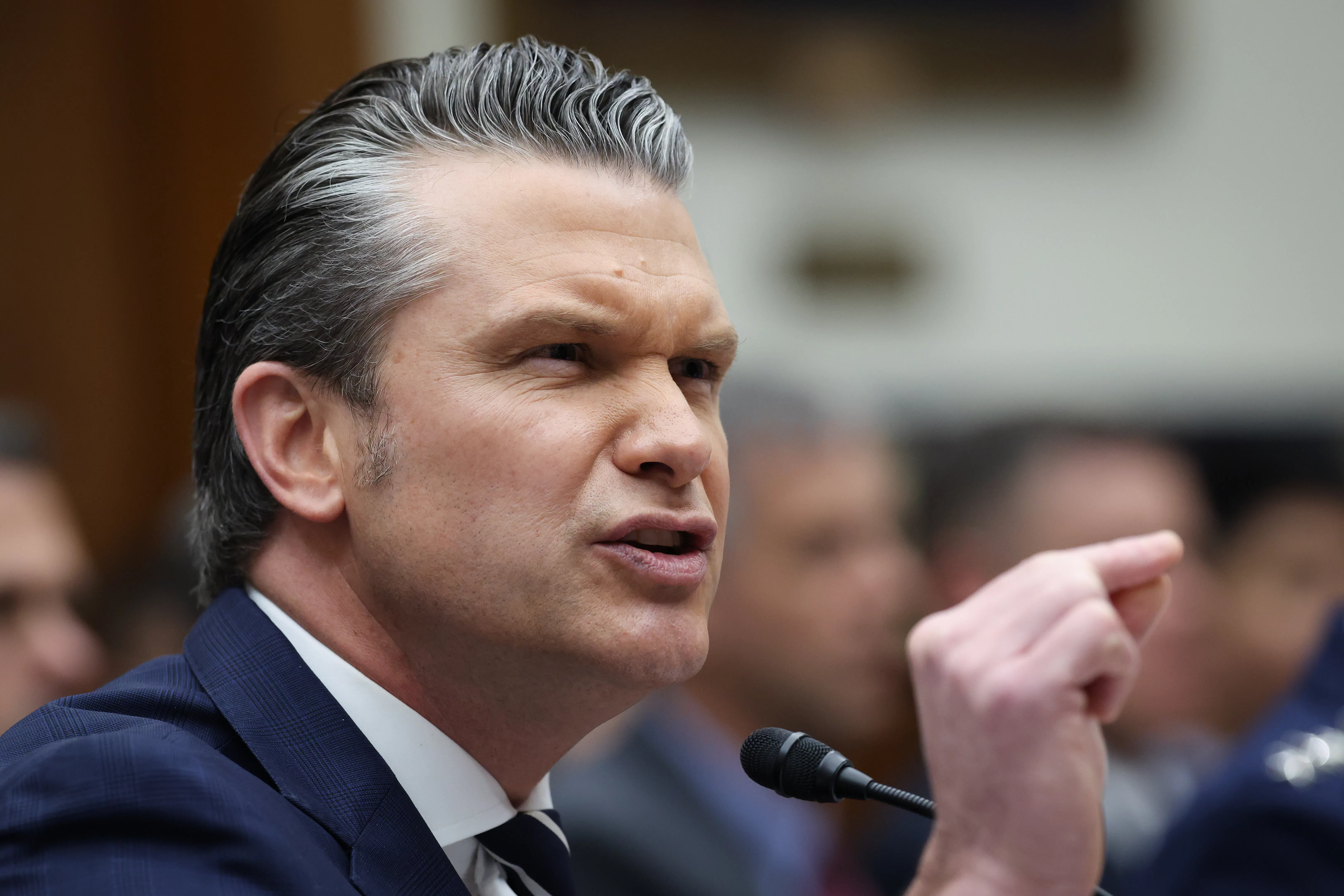 Defense Secretary Pete Hegseth gestures and speaks during a House committee hearing