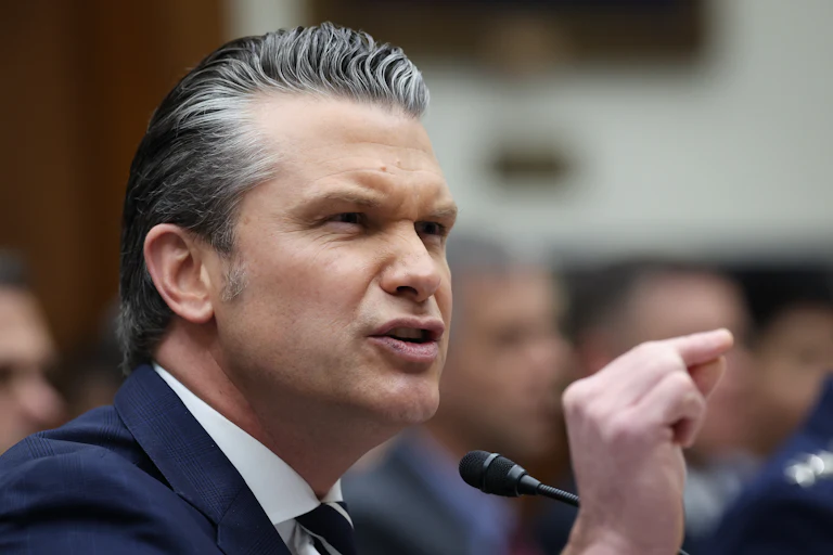 Defense Secretary Pete Hegseth gestures and speaks during a House committee hearing
