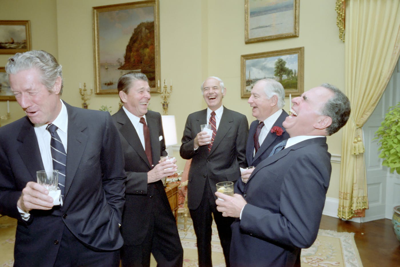 Ronald Reagan yukking it up in the White House in 1982 with four well dressed men including , Walter Annenberg.
