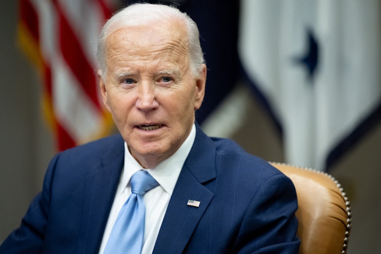 Joe Biden looks to the side while sitting