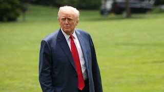 Donald Trump stares off as he walks across the White House lawn
