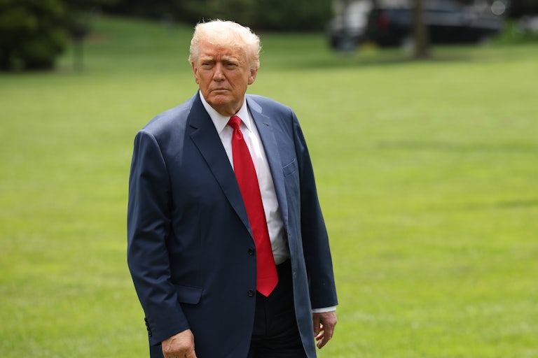 Donald Trump stares off as he walks across the White House lawn