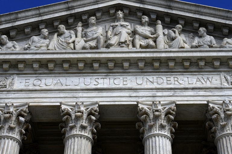 A close up of the facade of the Supreme Court building, where the words "Equal Justice Under Law" are etched.