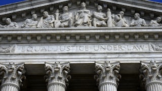 A close up of the facade of the Supreme Court building, where the words "Equal Justice Under Law" are etched.