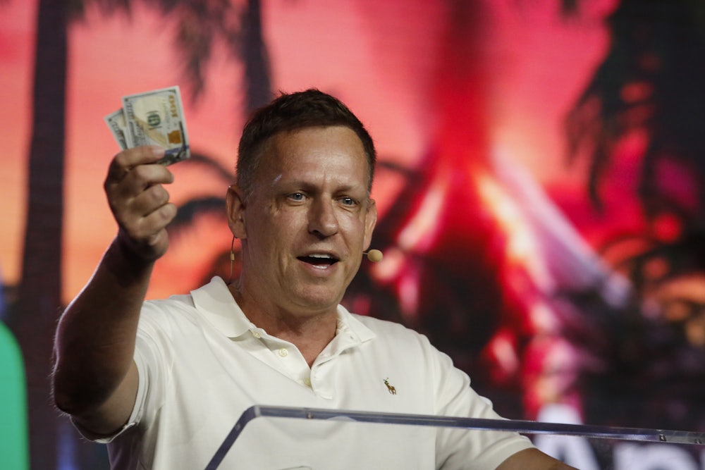 Palantir co-founder and chairman Peter Thiel holds money