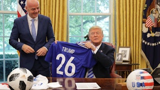 Donald Trump and FIFA President Gianni Infantino pose for photographs with a soccer uniform in the Oval Office.