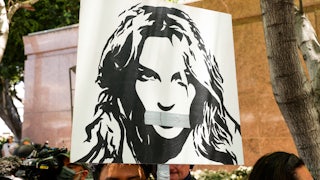 Activists supporting Britney Spears hold a sign aloft at a protest during the pop star's conservatorship hearing.
