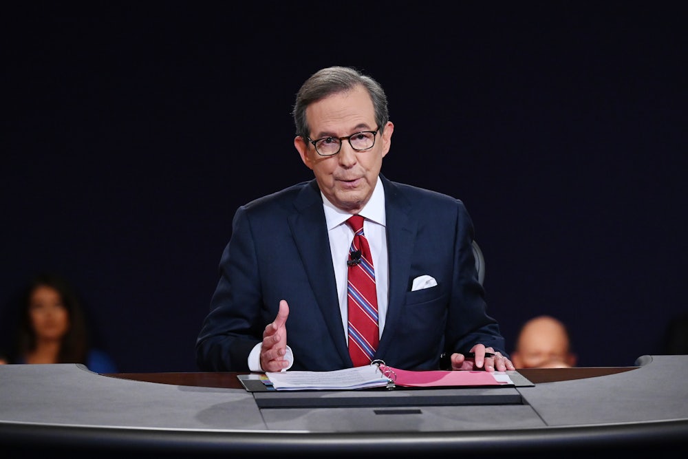 Fox News' Chris Wallace sits at a desk during a presidential debate.