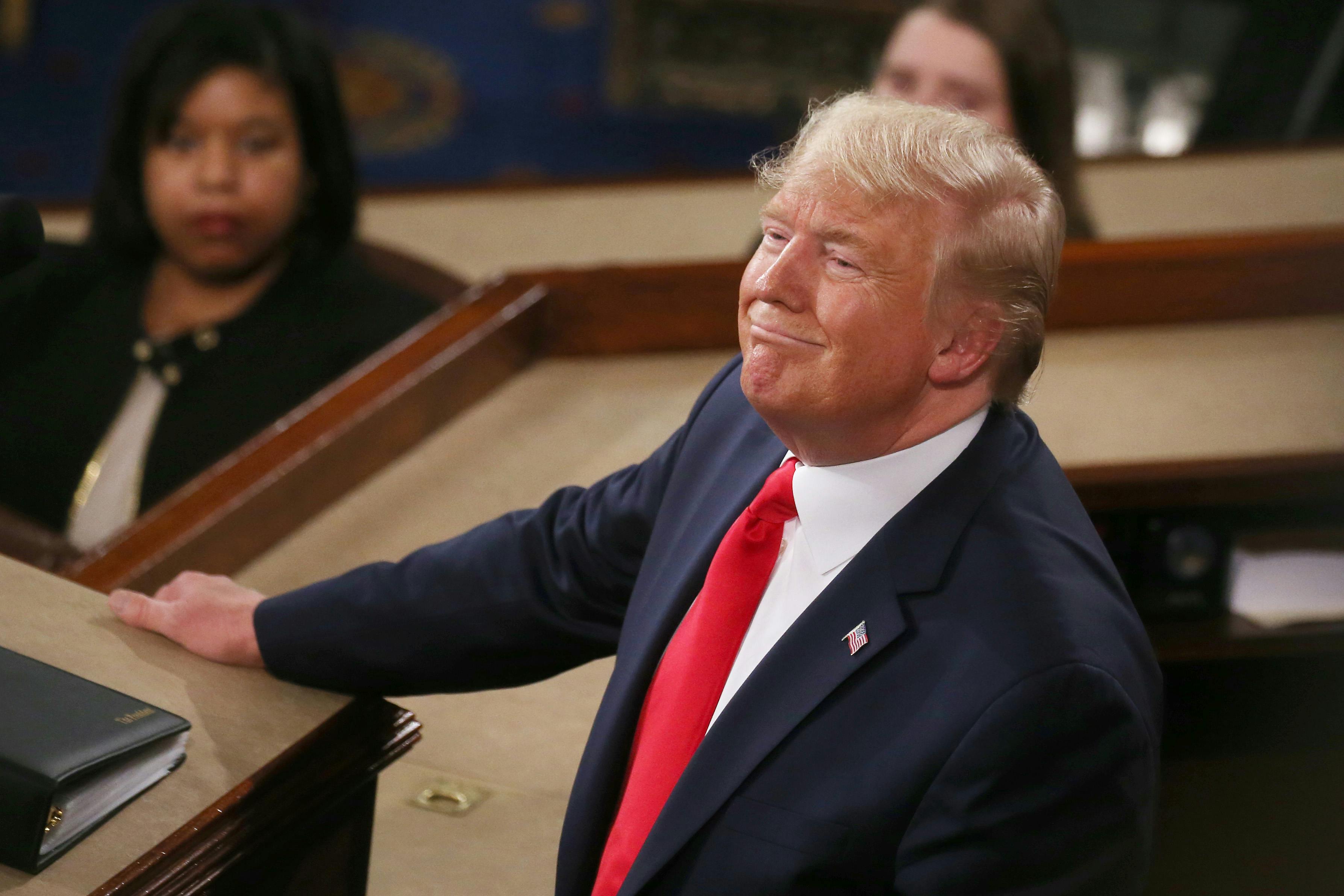 Trump looks up and smiles while delivering the State of the Union address 