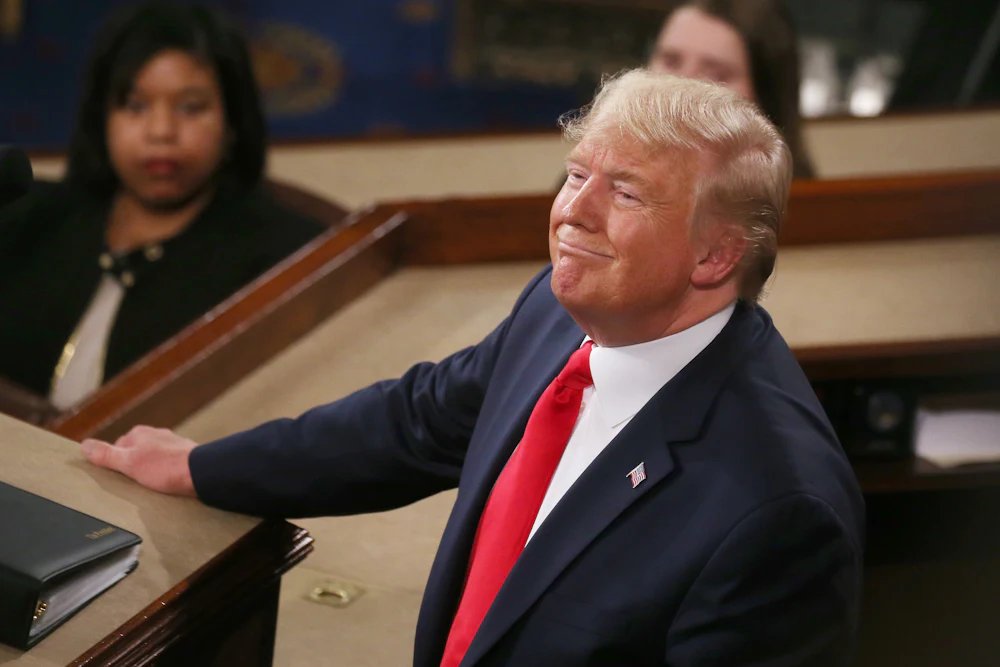 Trump looks up and smiles while delivering the State of the Union address