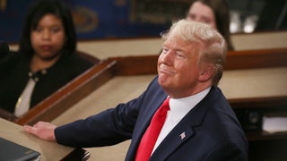 Trump looks up and smiles while delivering the State of the Union address