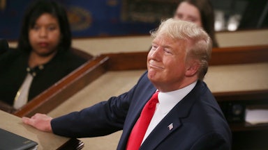 Trump looks up and smiles while delivering the State of the Union address