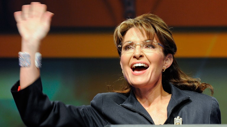 Sarah Palin waves.