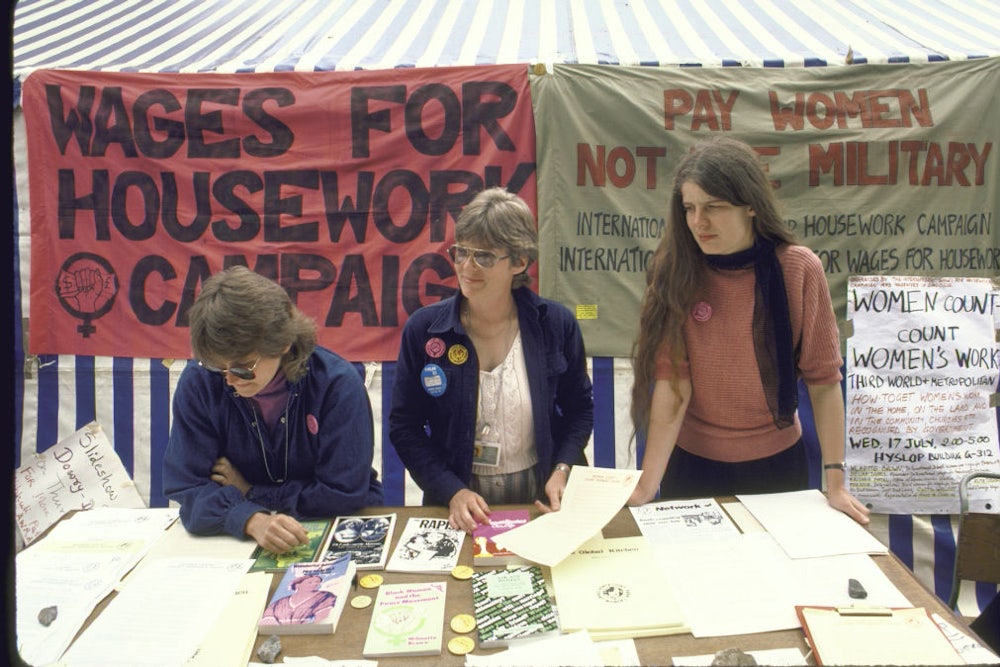 Three members of Wages for Housework Association at a literature table at Forum 1985, a women's conference in Nairobi, Kenya.