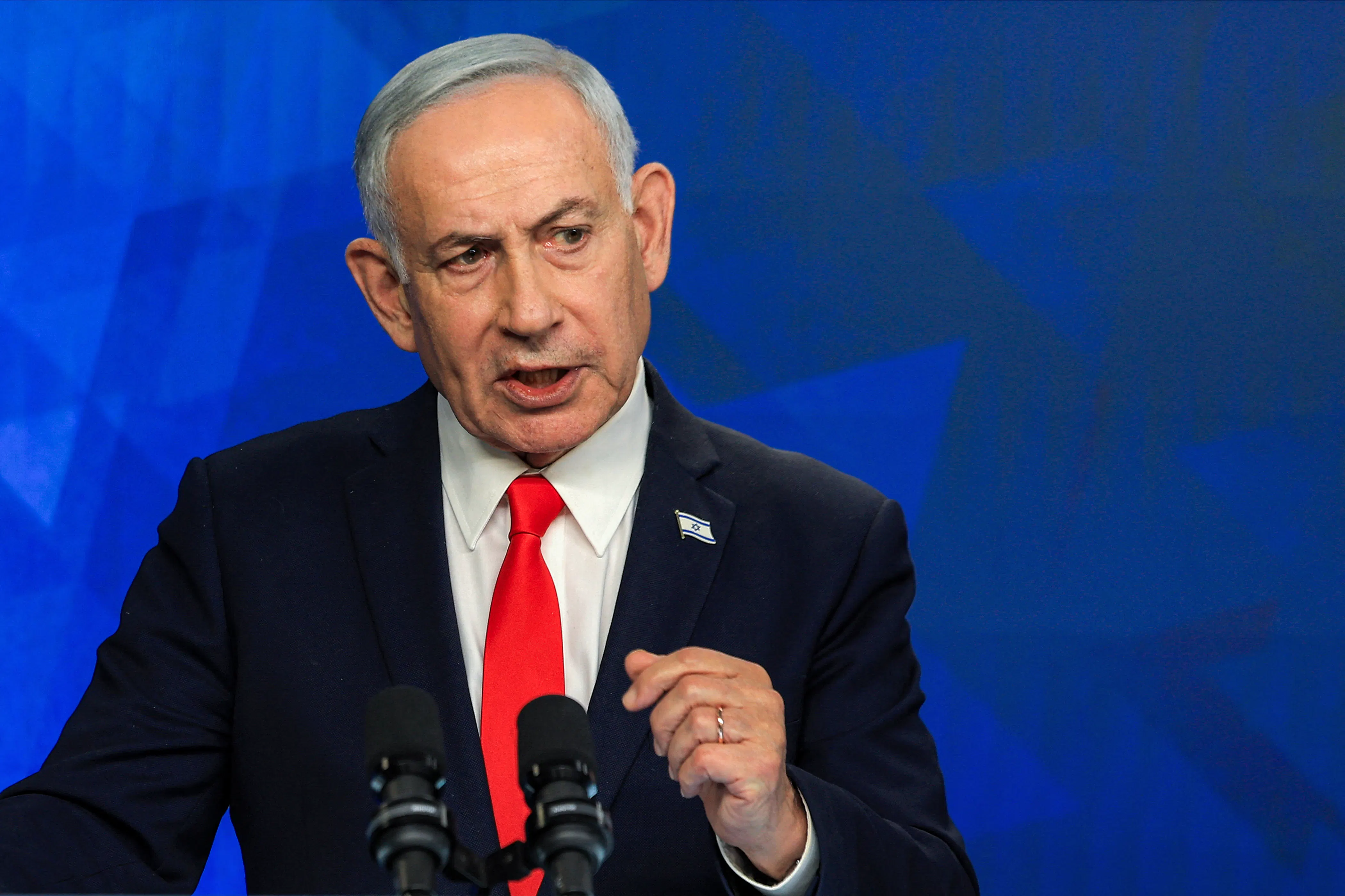 Israeli Prime Minister Benjamin Netanyahu speaks at a podium