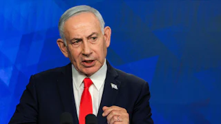 Israeli Prime Minister Benjamin Netanyahu speaks at a podium