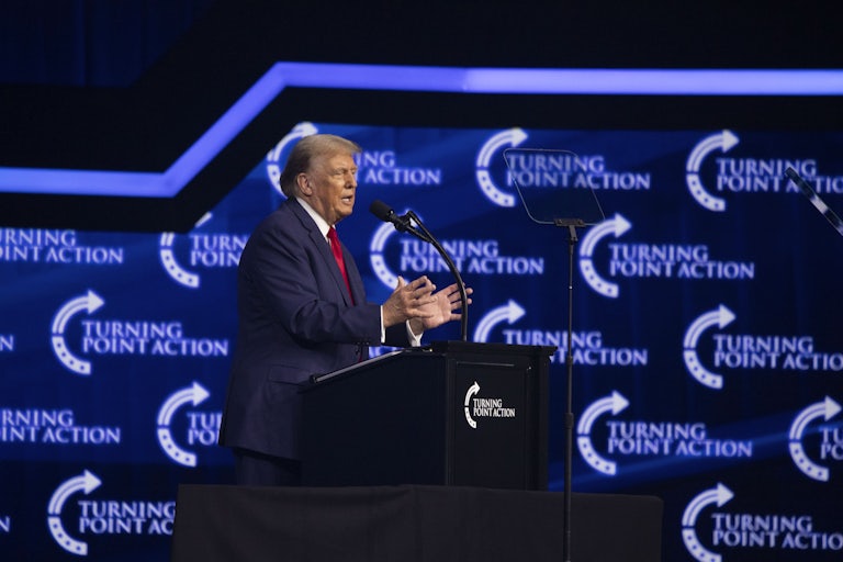 Donald Trump speaks at a podium