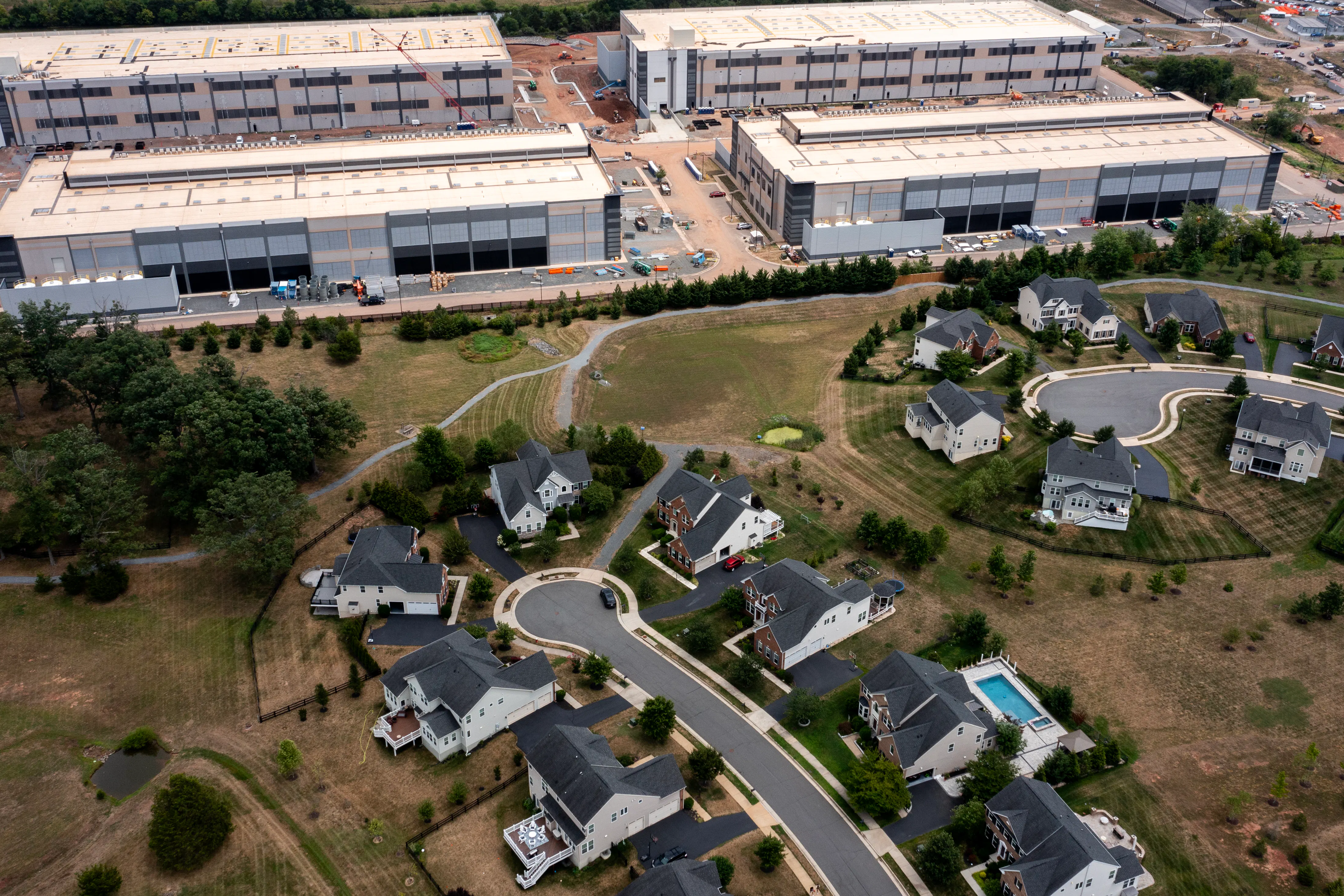 In an aerial view, an Amazon Web Services data center is shown situated near single-family homes in Stone Ridge, Virginia. Northern Virginia is the largest data center market in the world, according to a report this year cited in published accounts, but is facing headwinds from availability of land and electric power.