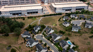In an aerial view, an Amazon Web Services data center is shown situated near single-family homes in Stone Ridge, Virginia. Northern Virginia is the largest data center market in the world, according to a report this year cited in published accounts, but is facing headwinds from availability of land and electric power.