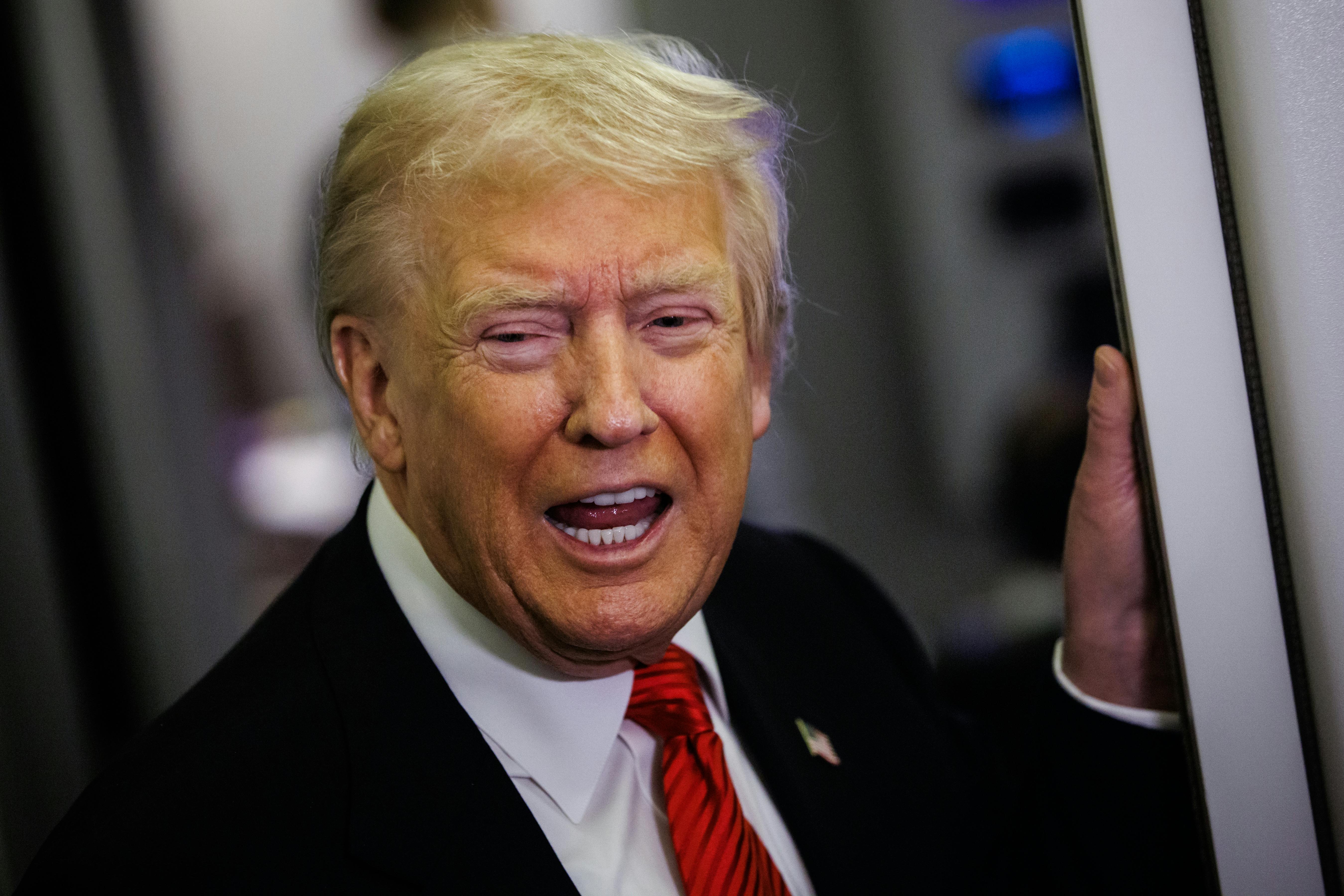 Trump speaks to reporters on plane