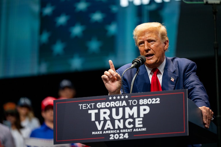 Donald Trump holds up a finger while speaking at a campaign event