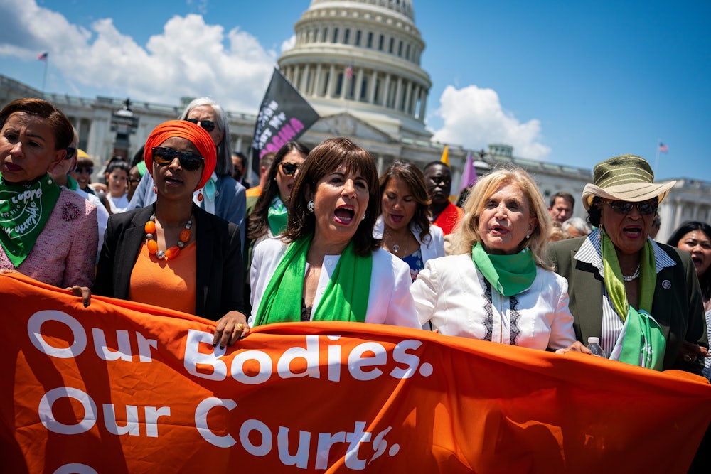 Democratic House members Ilhan Omar, Jackie Speier, Carolyn Maloney, and Alma Adams march toward the US Supreme Court during a July protest.
