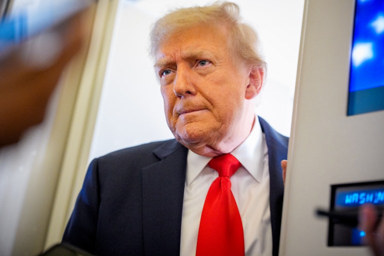 Donald Trump stands on Air Force One with reporters