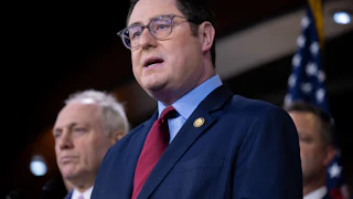 Representative Mike Flood speaks during a press conference