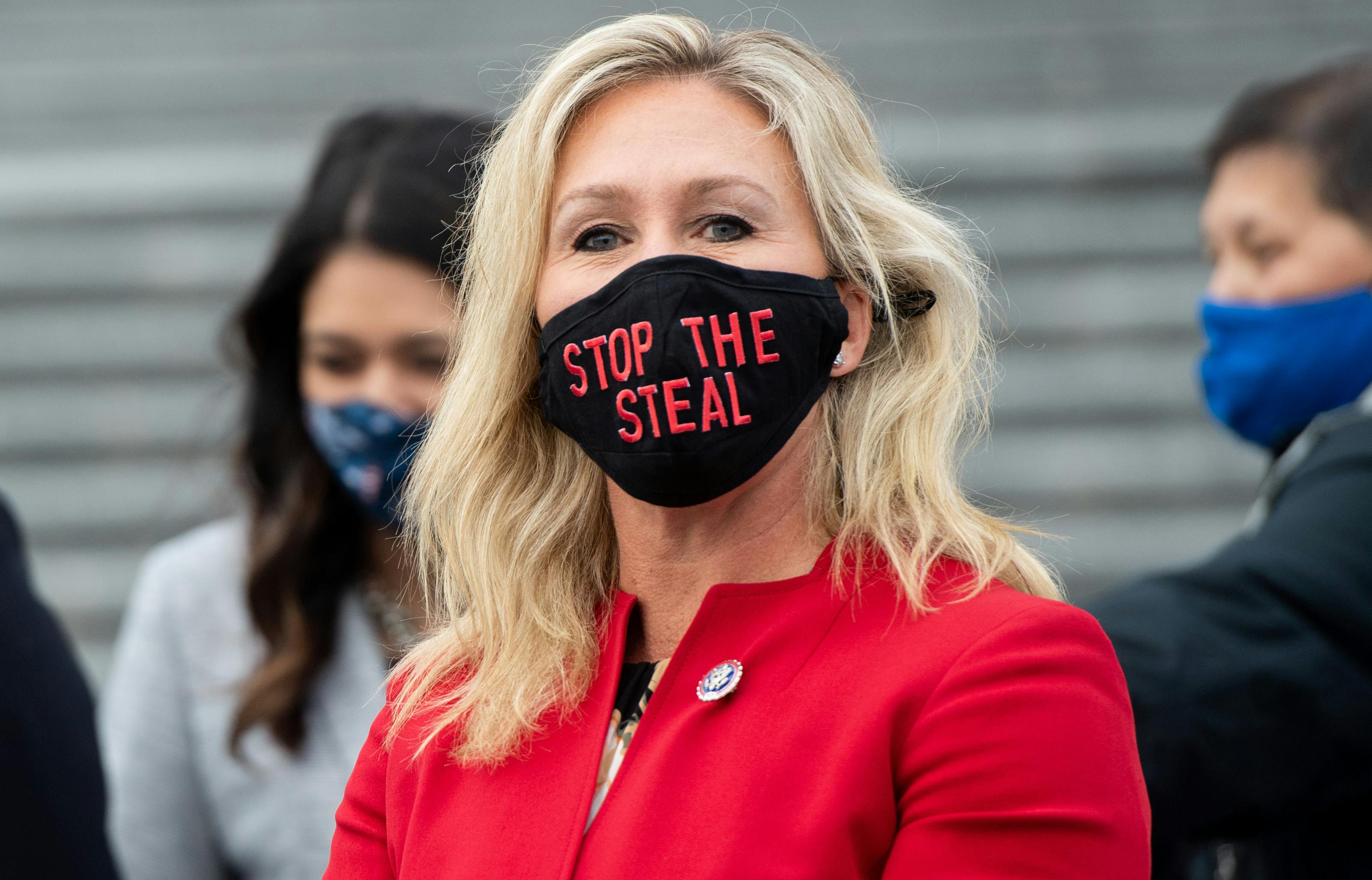 Marjorie Taylor Greene wears a “Stop the Steal” mask at the U.S. Capitol two days before the January 6 insurrection