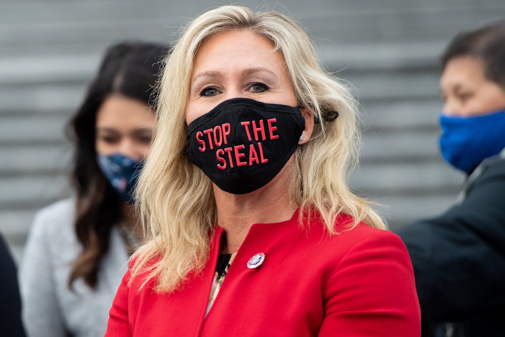 Marjorie Taylor Greene wears a “Stop the Steal” mask at the U.S. Capitol two days before the January 6 insurrection