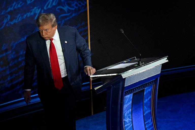 Donald Trump exhales through his mouth while walking off the presidential debate stage