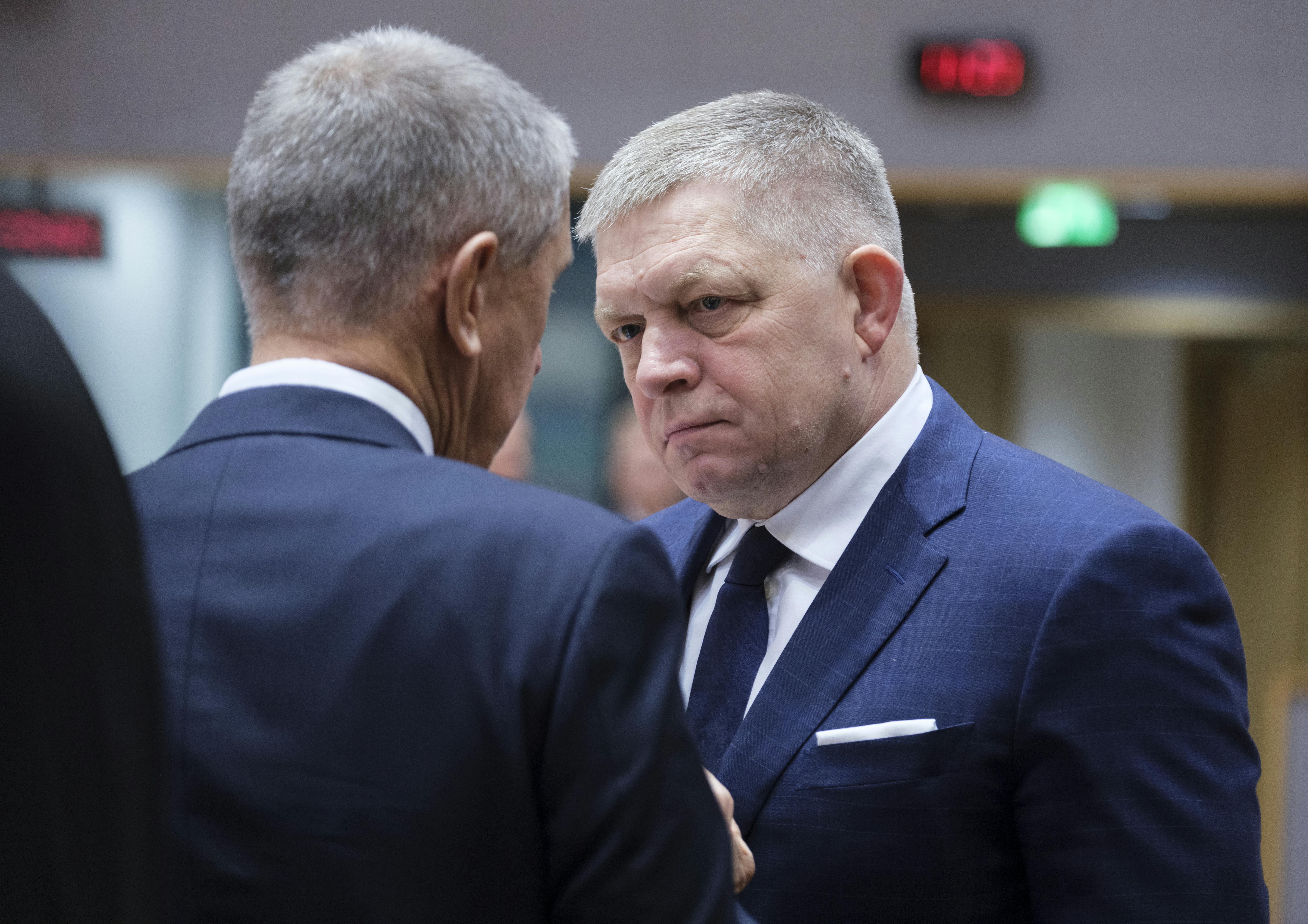 Slovak Prime Minister Robert Fico speaks to another man (face not pictured)