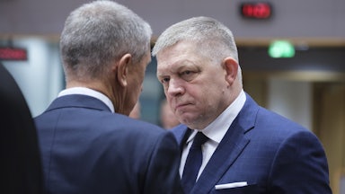 Slovak Prime Minister Robert Fico speaks to another man (face not pictured)