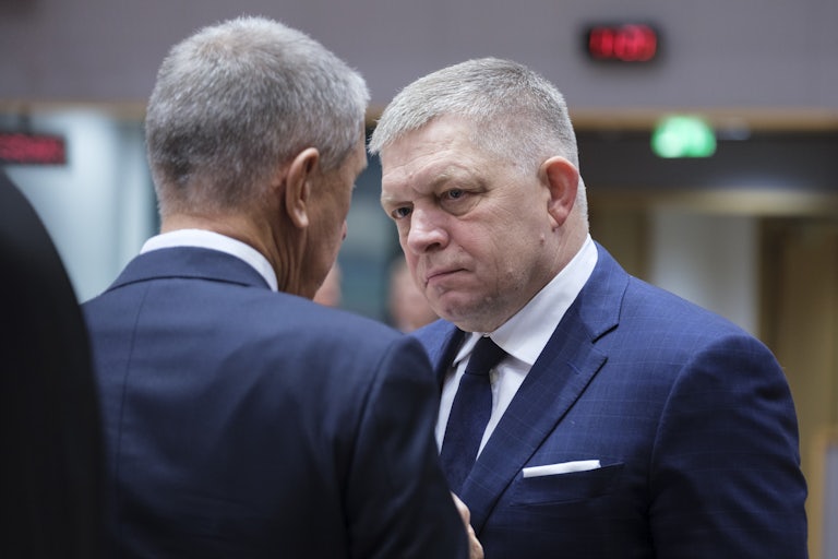 Slovak Prime Minister Robert Fico speaks to another man (face not pictured)
