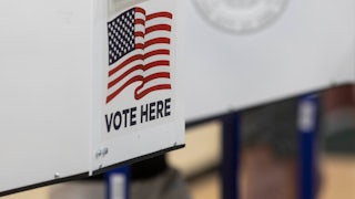 A "Vote Here" sign at a polling place.