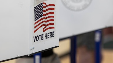A "Vote Here" sign at a polling place.
