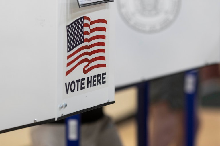 A "Vote Here" sign at a polling place.