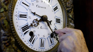 A man sets the clock back to mark the end of Daylight Saving Time.