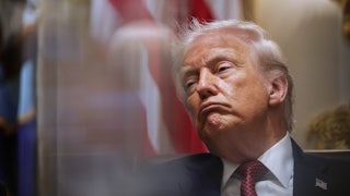 Donald Trump leans back while frowning