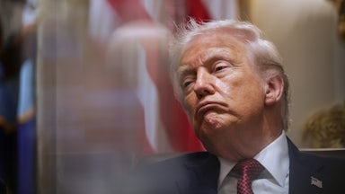 Donald Trump leans back while frowning